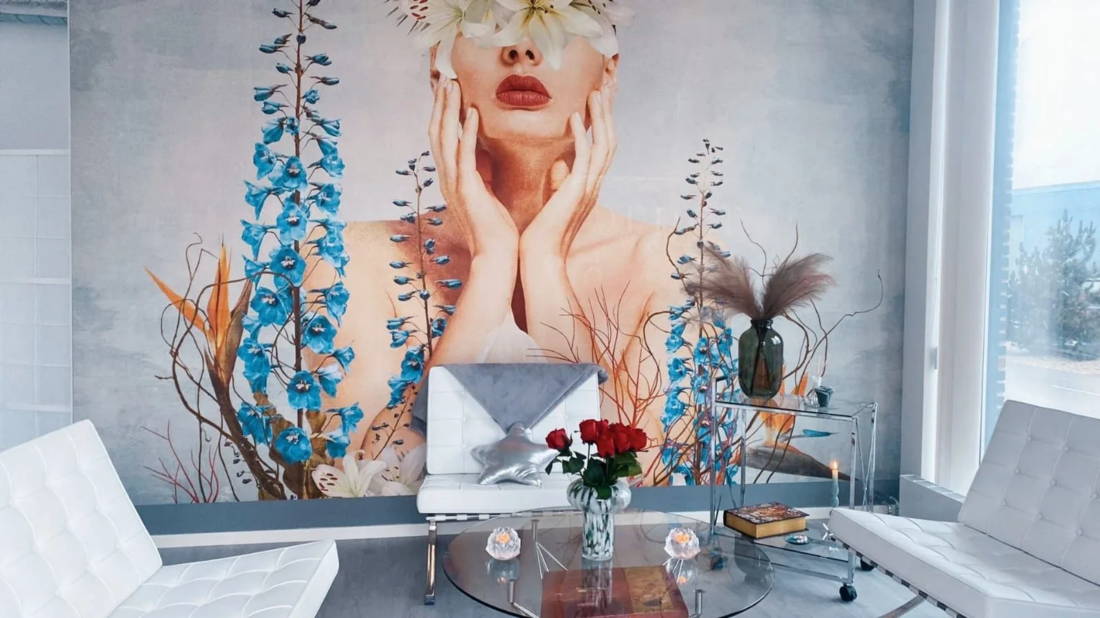 Väntrum med vita fåtöljer och blommig fondtapet hos Jojo Beauty Clinic i Malmö